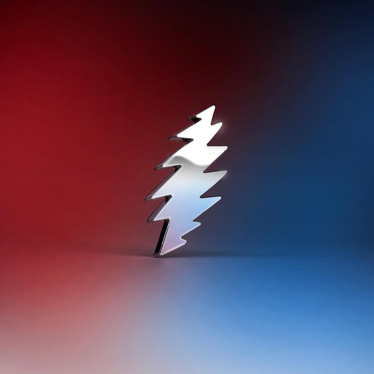 The Bolt metal badge featuring the iconic Grateful Dead lightning bolt design with red, white, and blue background