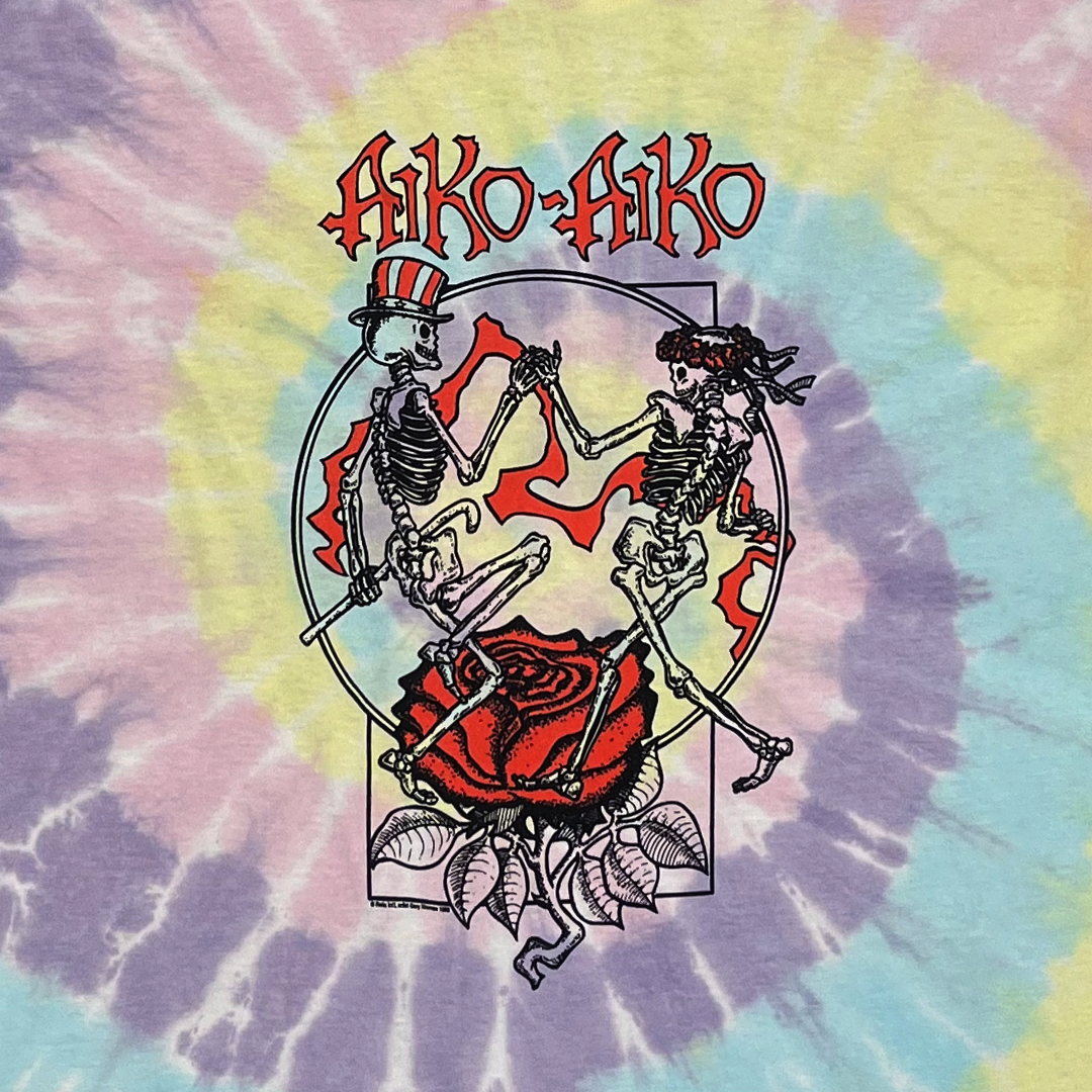Close-up of vintage Aiko Aiko band graphic on long sleeve tie-dye t-shirt