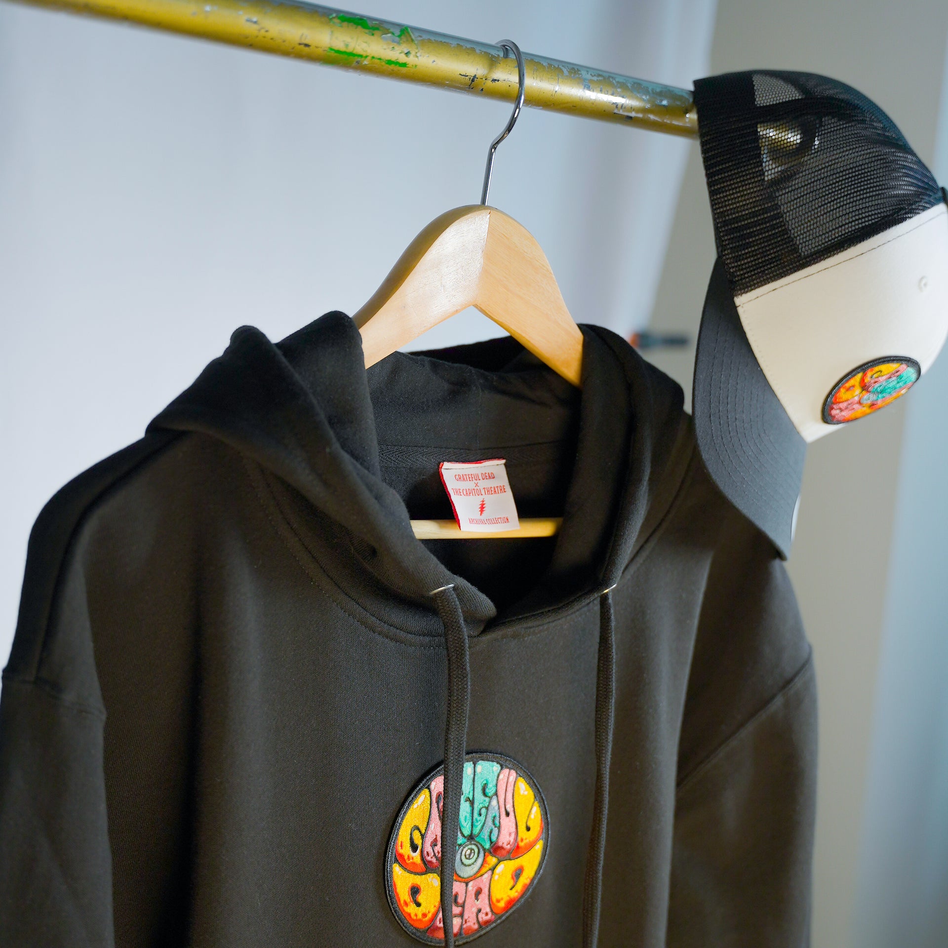 Grateful Dead hoodie by Drew Millward hanging on display, highlighting front graphic and relaxed fit