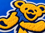 Close-up of the chenille Dancing Bear design on the Royal hoodie