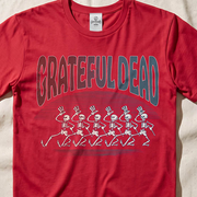 Close-up of the Dancing Skeleton Chorus Line print on a red t-shirt