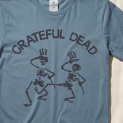 Close-up of the Dancing Skeletons print on an ice blue t-shirt