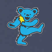 Close-up of the embroidered cyan bear on a navy bucket hat