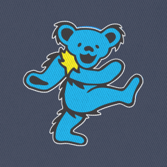 Close-up of the embroidered cyan bear on a navy bucket hat