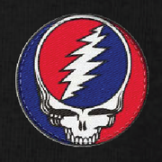 Close-up of the embroidered Stealie patch on a black thermal long-sleeve t-shirt