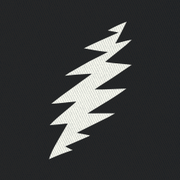 Close-up of the embroidered white bolt on a black bucket hat
