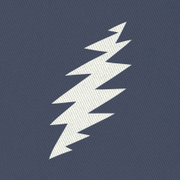 Close-up of the embroidered white bolt on a navy bucket hat
