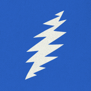 Close-up of the embroidered white bolt on a royal blue bucket hat