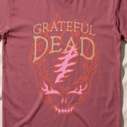 Close-up of the Flaming Steal Your Face print on a crimson t-shirt