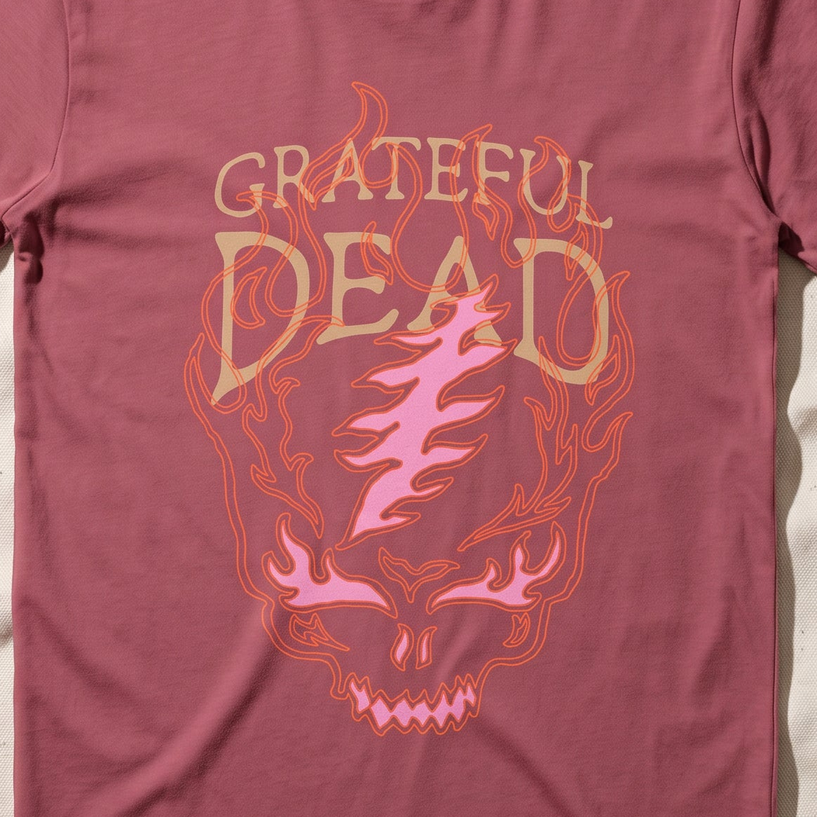 Close-up of the Flaming Steal Your Face print on a crimson t-shirt