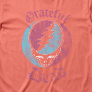 Close-up of the Stealie Stamp print on a bright salmon t-shirt