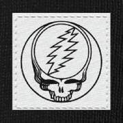 Close-up of the woven Stealie label on a black cuffed beanie