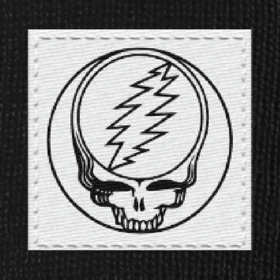 Close-up of the woven Stealie label on a black cuffed beanie
