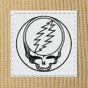 Close-up of the woven Stealie label on a camel cuffed beanie