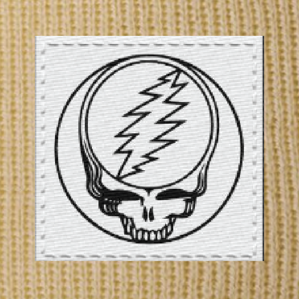 Close-up of the woven Stealie label on a camel cuffed beanie