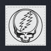 Close-up of the woven Stealie label on a navy cuffed beanie