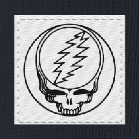 Close-up of the woven Stealie label on a navy cuffed beanie
