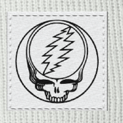 Close-up of the woven Stealie label on a white cuffed beanie
