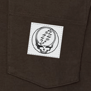 Close-up of the woven Stealie label on the pocket of a brown long-sleeve t-shirt