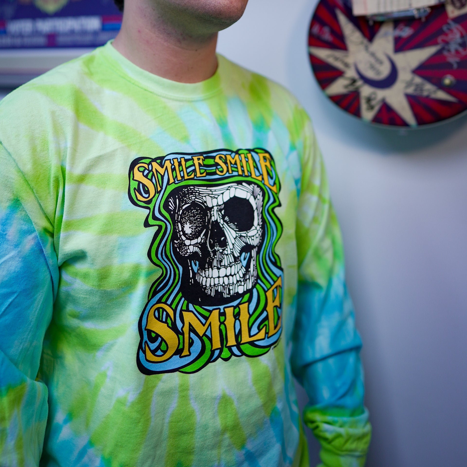 Side view of model wearing Smile Smile Smile throwback long sleeve tie-dye t-shirt