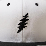 Close-up of the design on the Grateful Dead Embroidered Black Bolt Snapback Hat - Natural/Black