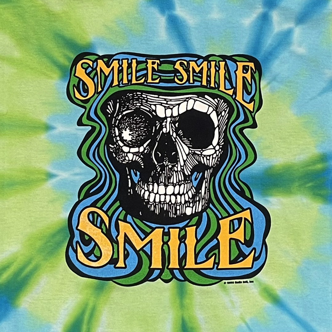 Close-up of retro Smile Smile Smile graphic on tie-dye long sleeve t-shirt